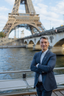 A photo of Thierry Jupsin, VP of Brand Marketing for Bridgestone EMEA, in front of the Eiffel Tower in Paris