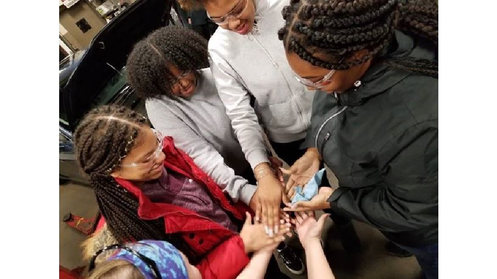 Firestone Complete Auto Care employees educate Girl Scouts