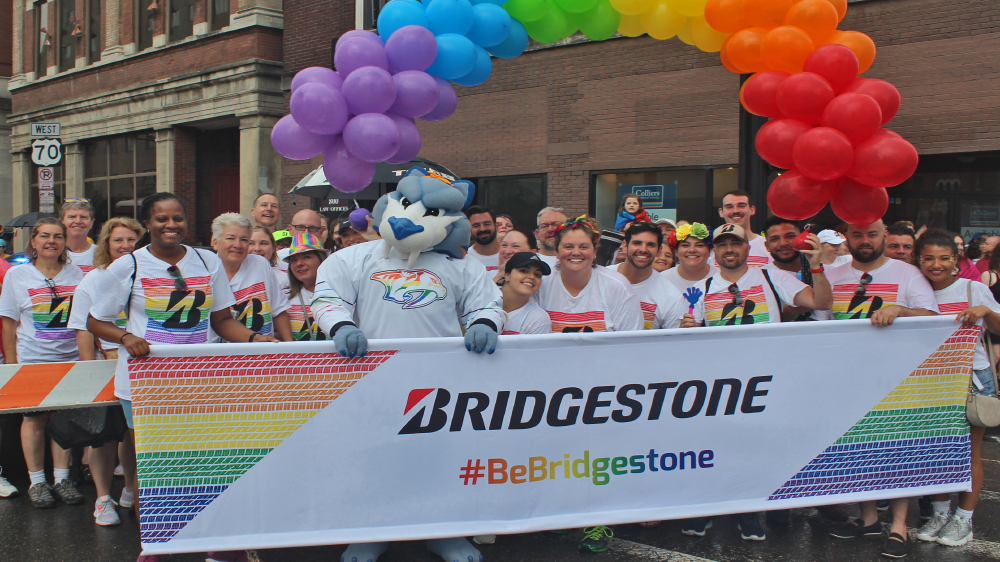 Bridgestone employees and nashville predators mascot gnash walking in