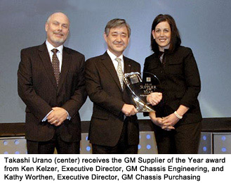 Takashi Urano receiving the GM Supplier of the Year award