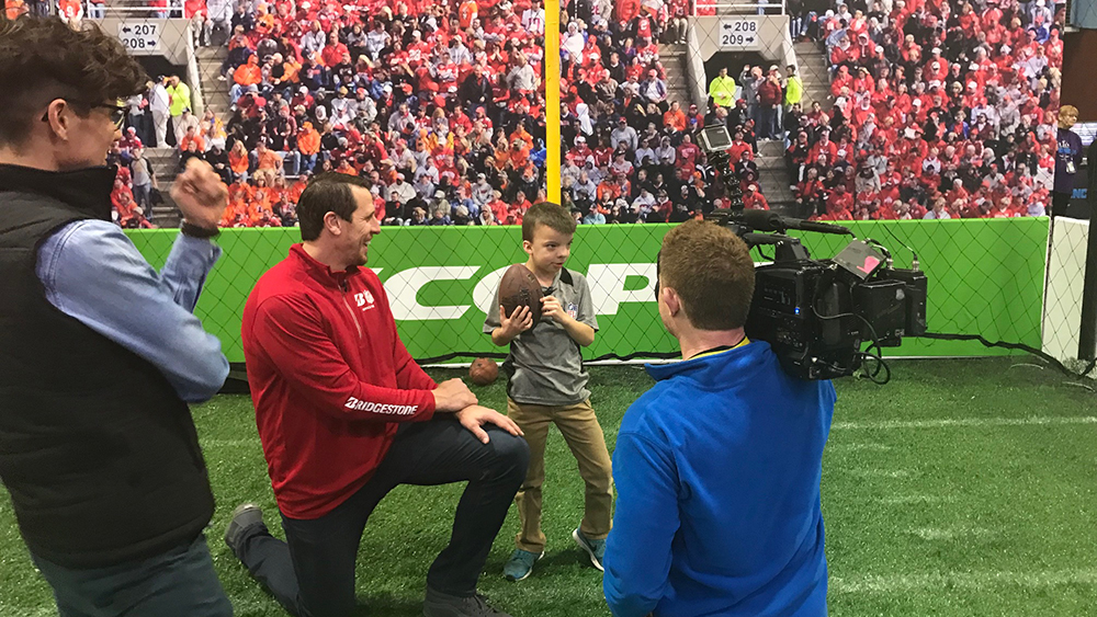 Former NFL Pro Bowler Chad Greenway and 8-year-old football fan Obadiah Gamble at Super Bowl LII Experience