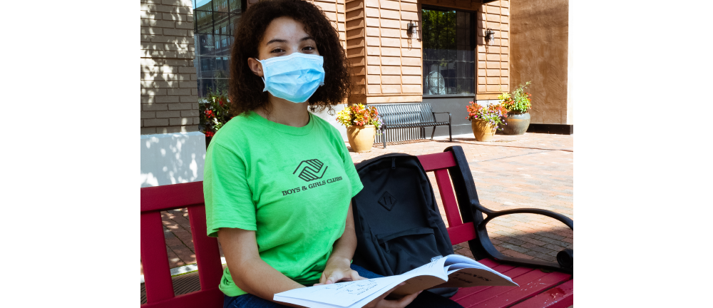 boys and girls club kid wearing a mask and studying