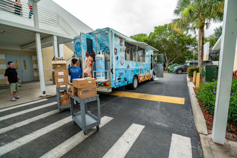 boys and girls clubs staff loading boxes