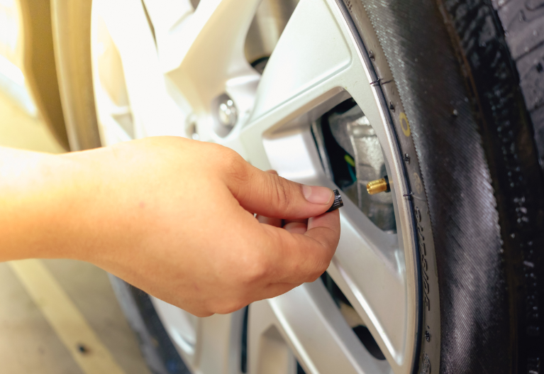 Hand removing a tire black. Check the tire air pressure.