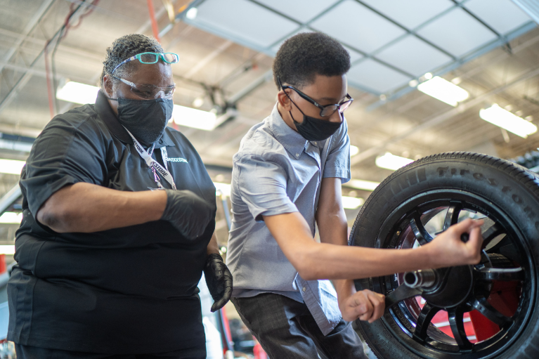 Ms. TJ Williams, Auto Training Center instructor and part-time Bridgestone employee, with one of her current training center students