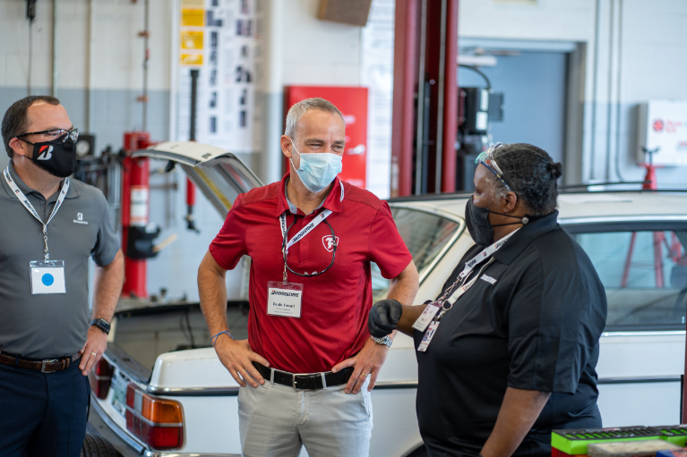 From left to right: Robert Johnson, Vice President of Stores, Bridgestone Retail Operations; Paolo Ferrari, President and CEO, Bridgestone Americas; Ms. TJ Williams, Maplewood Auto Training Center instructor and part-time Bridgestone employee