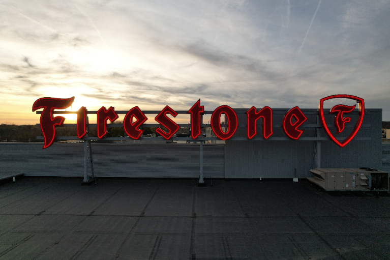 The iconic Firestone sign on the top of the ATPC building close up.