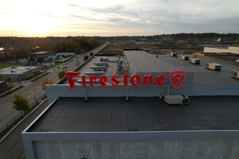 The iconic Firestone sign on the top of the ATPC building.