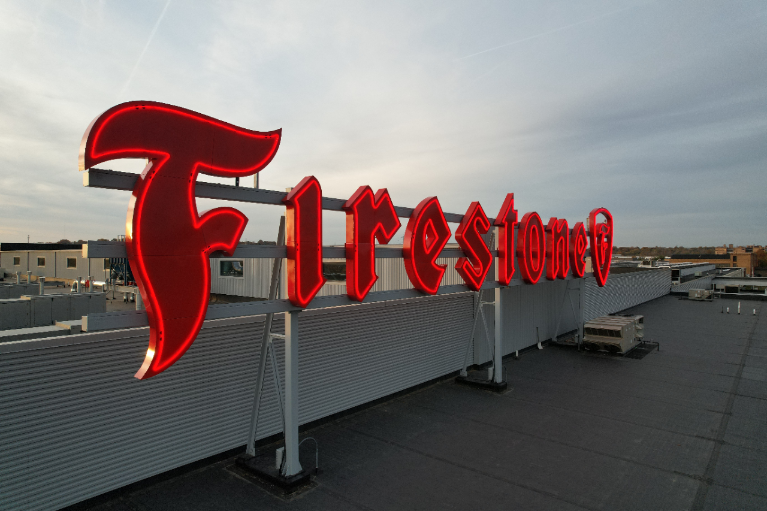 The iconic Firestone sign on the top of the ATPC building from a side angle.