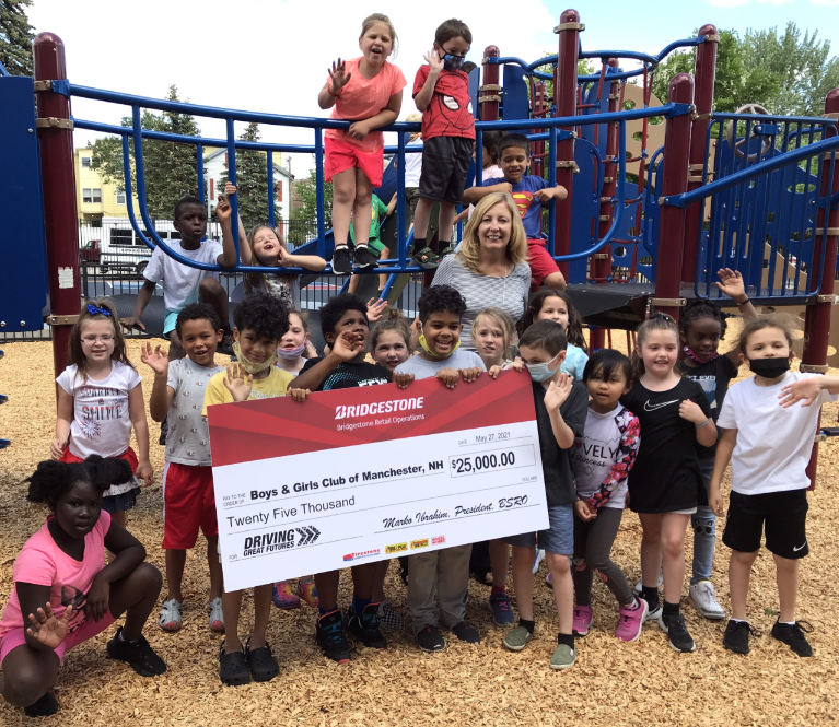 Diane Fitzpatrick, CEO, Boys & Girls Club of Manchester (pictured at center) shares the news with Manchester, NH area Club Kids.