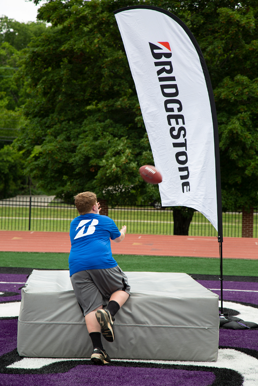 A Boys & Girls Club youth from Middle Tennessee catches a pass from a TEU athlete.