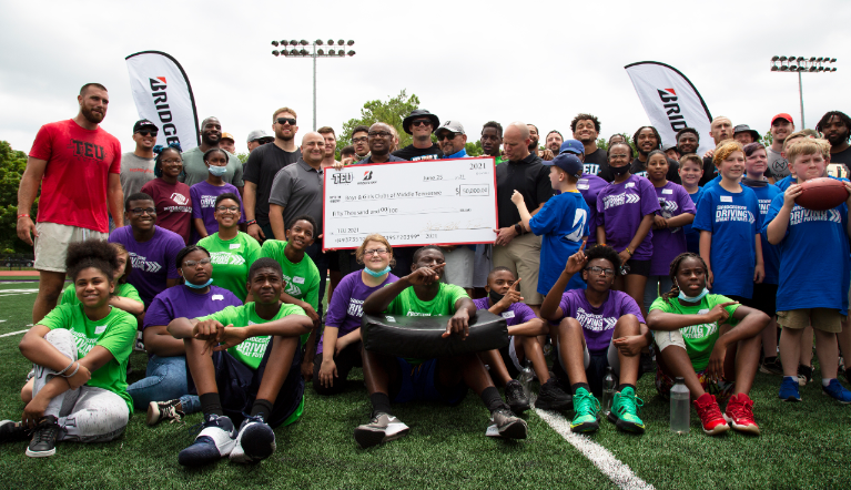 Bridgestone Retail Operations and Tight End University present a check for $50,000 to Boys & Girls Clubs of Middle Tennesse.