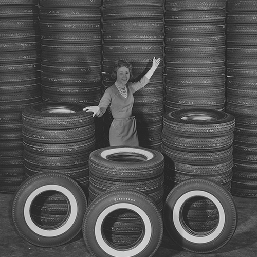Woman in front of tires