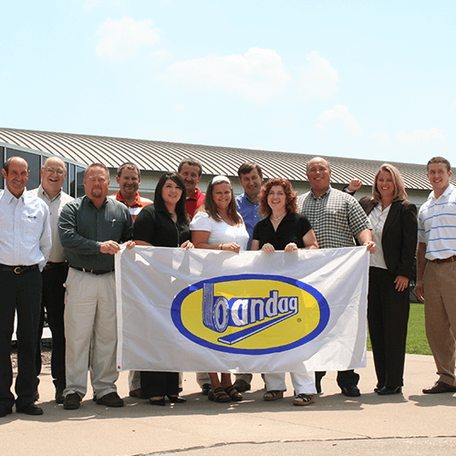 Staff holding a bandag flag