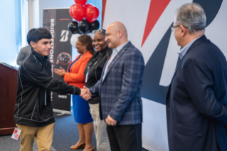 Bridgestone Retail Operations President Marko Ibrahim congratulates Maplewood Automotive student