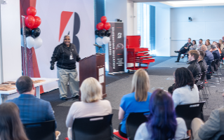 Ms. TJ, Maplewood High School’s Automotive Training Center Instructor, speaks at the awards ceremony