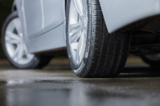 DriveGuard Plus tires on a sedan, close-up of tread on the ground