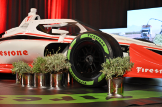 Guayule tire on Firestone INDYCAR next to guayule plants