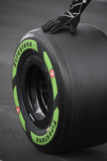 Close-up of someone rolling guayule tire on the ground