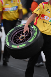 Pit crew holding guayule tire