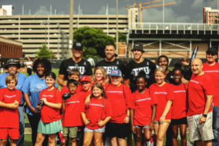 Kids pose with Greg Olsen, Travis Kelce, George Kittle and Marko Ibrahim at TEU Summit 2023.