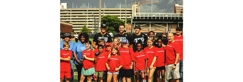 Kids pose with Greg Olsen, Travis Kelce, George Kittle and Marko Ibrahim at TEU Summit 2023.