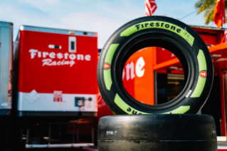 Guayule tire in front of Firestone Racing garage