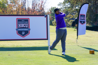 HBCU Men’s Golfer Swings in front of Tournament Signage