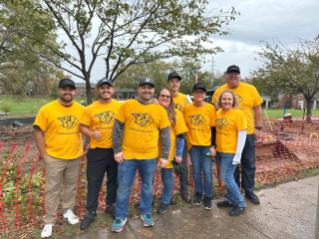 Group photo of Bridgestone employees volunteering to help build a playground in support of the company's 2024 United by What Really Matters campaign.