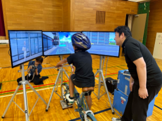 Bridgestone teammates guide children through cycling simulations to promote road safety in Japan.