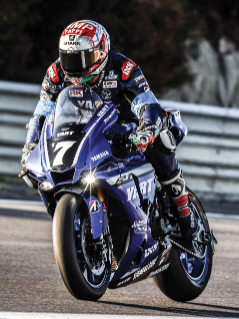 Image of a rider on a blue motorcycle