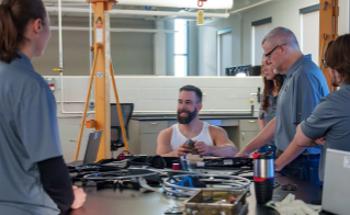 Paralympian Aaron Pike chats with Bridgestone engineers at the Americas Technology Center in Akron, Ohio.