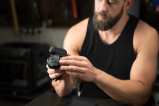 Paralympian Aaron Pike applies Bridgestone rubber pads to his wheelchair racing gloves.
