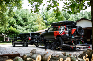 Nissan Titan outfitted with Firestone Airide towing Toyota 4Runner.