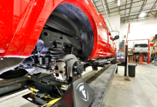 Firestone Airide being installed on a truck in an auto shop.