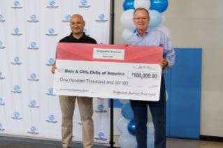 Marko Ibrahim, President of Bridgestone Retail Operations, presents a $100,000 to Boys & Girls Clubs of America CEO Jim Clark.