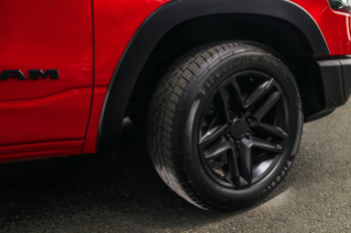 The Firestone Destination LE4 highway touring tire mounted on red vehicle.